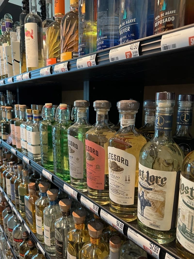 A shelf of liquor at The Good Pour Naples