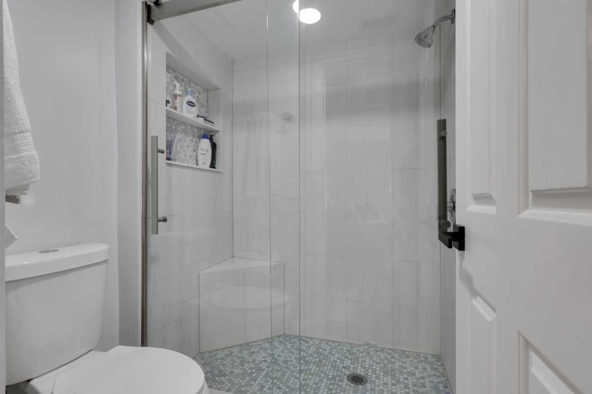 The tiled bathroom at 3031 Sandpiper Bay CIrcle #F106 that's for sale in Naples, Florida