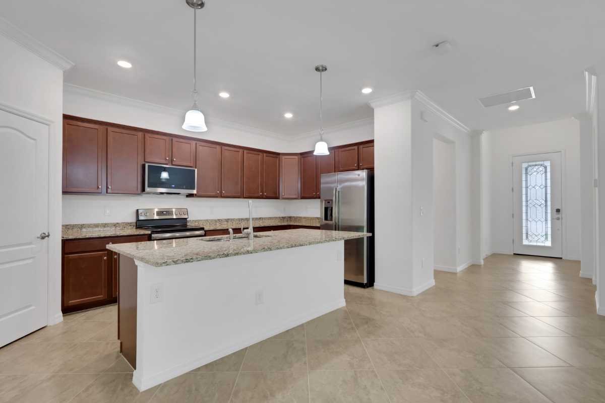The kitchen island and walk-in pantry at 9469 Foxglove Lane in Bent Creek Preserve