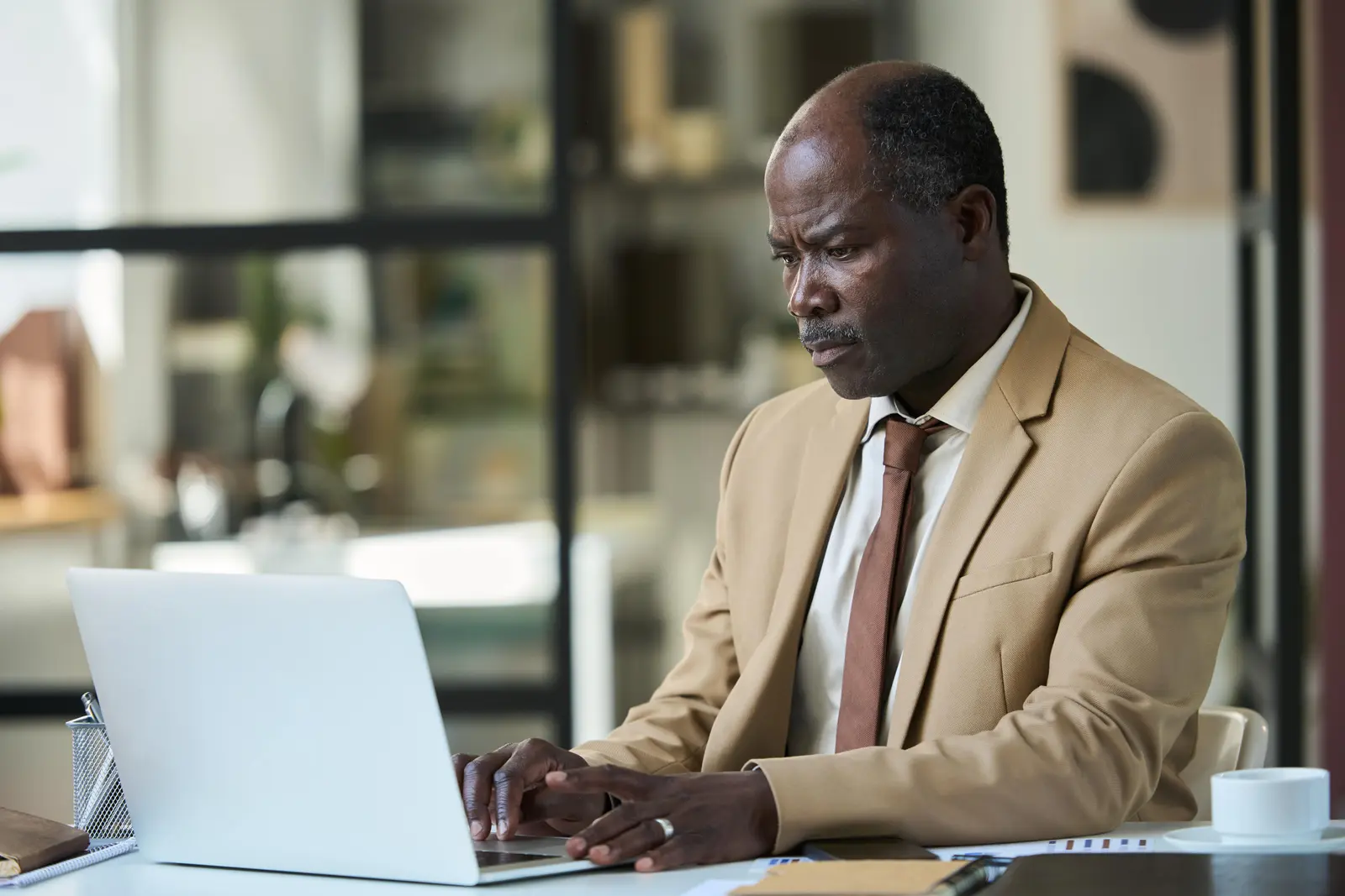 Self-employed professional reviewing mortgage documents on a laptop.