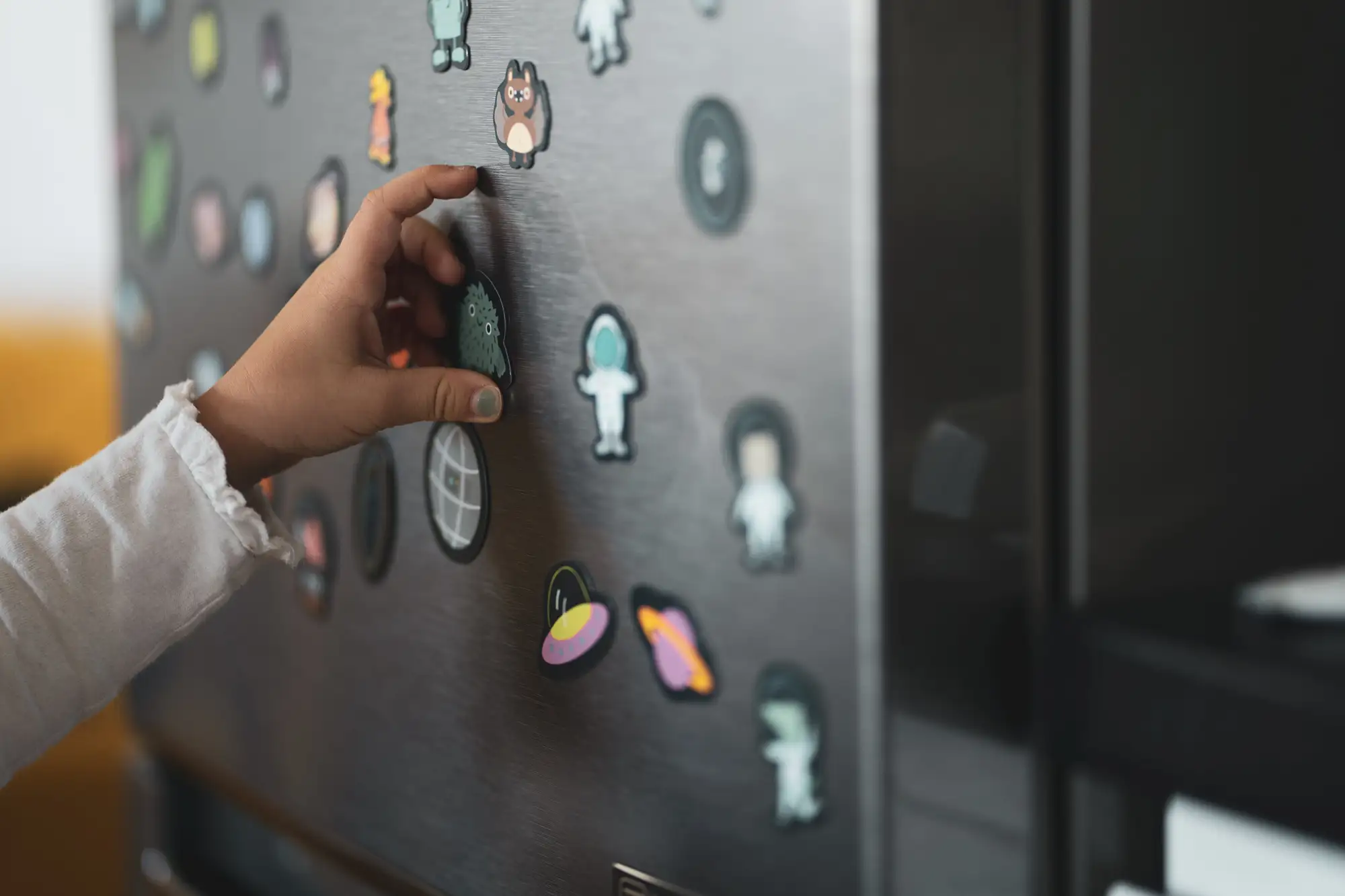 Refrigerator with lots of magnets in a real estate listing.